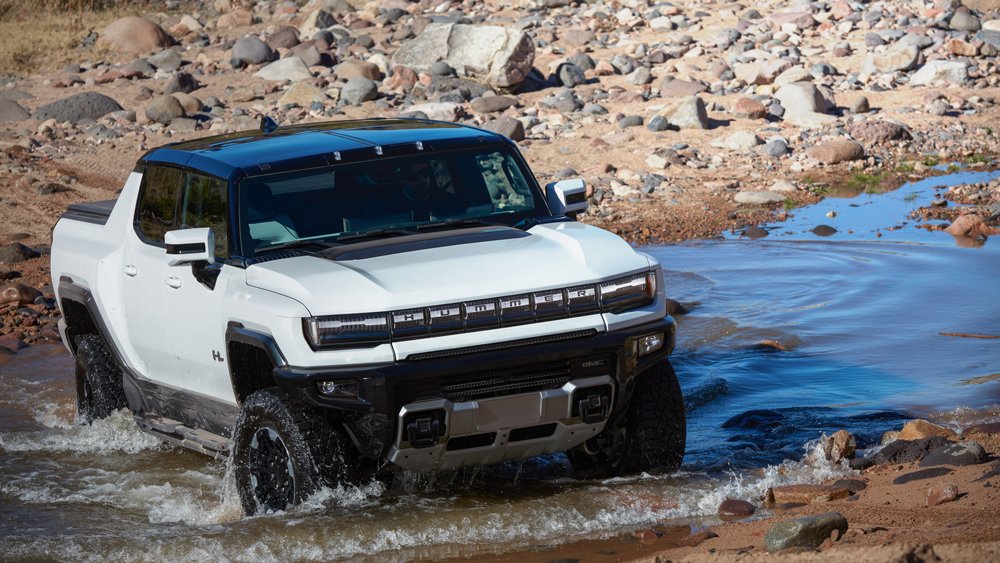 The 2022 Hummer EV Pickup being driven off-road.