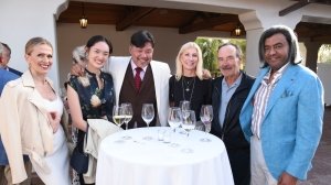 Participants in Robb Report's 2022 California Coastal road rally mingle at the welcome reception.